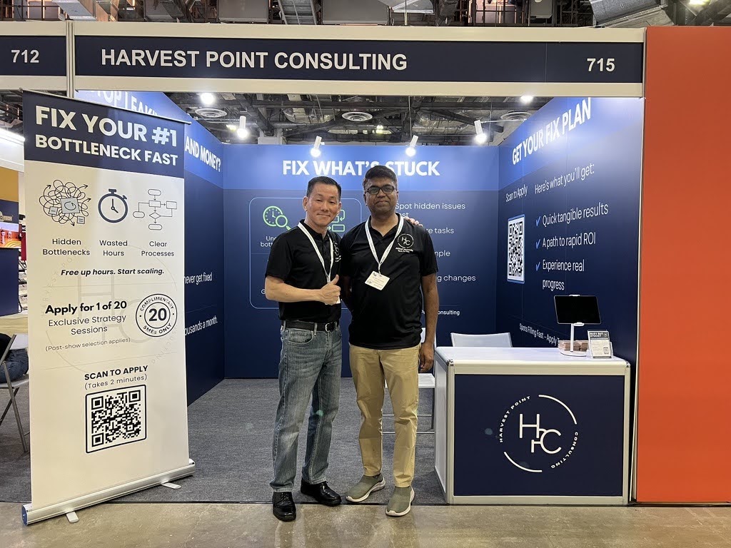 Clifford Tan, on the left, at Harvest Point Consulting’s stand